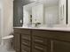 Modern bathroom with a dual sink vanity, dark cabinets, and a large mirror at 280 Rockledge Sw Bnd, Powder Springs, GA 30127