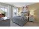 Inviting bedroom features large windows, stylish decor, a gray bed frame, and soft, neutral colors at 280 Rockledge Sw Bnd, Powder Springs, GA 30127