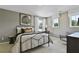 Comfortable bedroom with natural light, desk space, neutral colors, and stylish decor at 280 Rockledge Sw Bnd, Powder Springs, GA 30127