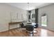 Bright dining area features wood floors, a modern table, and decorative artwork on the wall at 280 Rockledge Sw Bnd, Powder Springs, GA 30127