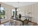 Elegant dining room featuring a glass-top table, stylish chairs, and natural light from nearby windows at 280 Rockledge Sw Bnd, Powder Springs, GA 30127