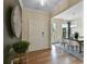 Bright entryway showcasing hardwood floors, a decorative wall hanging, and a glimpse into the dining room at 280 Rockledge Sw Bnd, Powder Springs, GA 30127