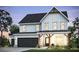 Charming two-story home featuring board and batten siding, a black shingle roof, and a two-car garage at 280 Rockledge Sw Bnd, Powder Springs, GA 30127