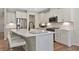 Bright kitchen with white cabinets, stainless steel appliances, an island with seating, and marble countertops at 280 Rockledge Sw Bnd, Powder Springs, GA 30127
