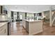 Open-concept kitchen featuring stainless steel appliances, a center island with a sink, and hardwood flooring at 280 Rockledge Sw Bnd, Powder Springs, GA 30127