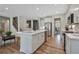 Modern kitchen featuring stainless steel appliances, an island with seating, and hardwood floors at 280 Rockledge Sw Bnd, Powder Springs, GA 30127
