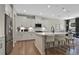 Well-lit kitchen with white cabinets, stainless steel appliances, a center island and hardwood floors at 280 Rockledge Sw Bnd, Powder Springs, GA 30127