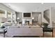 Bright living room featuring a fireplace, large windows, and a comfortable seating area at 280 Rockledge Sw Bnd, Powder Springs, GA 30127