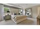 Serene main bedroom with a tufted headboard, large mirror, and ample natural light from the windows at 280 Rockledge Sw Bnd, Powder Springs, GA 30127