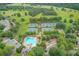 Aerial view showcasing community tennis courts, swimming pool, and playground amidst lush greenery at 4865 Meadow Park Ln, Suwanee, GA 30024