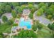 Aerial view featuring a large pool and clubhouse surrounded by lush greenery and ample parking at 4865 Meadow Park Ln, Suwanee, GA 30024