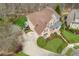 Stunning aerial view of a brick home with a manicured lawn and mature landscaping at 4865 Meadow Park Ln, Suwanee, GA 30024