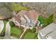 Gorgeous aerial of a two-story home featuring a brick facade and lush, green lawn at 4865 Meadow Park Ln, Suwanee, GA 30024