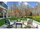 Backyard patio with outdoor seating around a gas fire pit providing a cozy outdoor living space at 4865 Meadow Park Ln, Suwanee, GA 30024