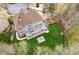 Aerial shot of the backyard featuring a spacious deck overlooking a lush green lawn and fire pit at 4865 Meadow Park Ln, Suwanee, GA 30024