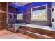 Bathroom featuring a soaking tub, elegant tile and modern lighting at 4865 Meadow Park Ln, Suwanee, GA 30024