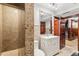Granite tiled shower with white vanity, and updated fixtures in this stylish bathroom at 4865 Meadow Park Ln, Suwanee, GA 30024
