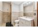 Modern bathroom with stone tile, black tile floor, and a contemporary vanity at 4865 Meadow Park Ln, Suwanee, GA 30024