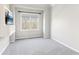 Well-lit bedroom with neutral colors, plush carpet, and a modern wall-mounted television at 4865 Meadow Park Ln, Suwanee, GA 30024
