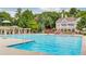 Resort-style community pool with ample seating and a charming clubhouse for relaxation and recreation at 4865 Meadow Park Ln, Suwanee, GA 30024