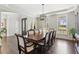 Elegant dining room with wood floors, chandelier, tray ceiling and a view of the outdoors at 4865 Meadow Park Ln, Suwanee, GA 30024