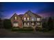 Charming brick home with a welcoming front porch and meticulously landscaped front yard at 4865 Meadow Park Ln, Suwanee, GA 30024