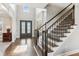 Grand foyer featuring high ceilings, hardwood floors, staircase, and elegant lighting at 4865 Meadow Park Ln, Suwanee, GA 30024