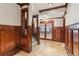 Grand foyer with beautiful wood paneling, a stone tile floor, and a stunning staircase at 4865 Meadow Park Ln, Suwanee, GA 30024