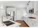 An open kitchen with marble counters, white cabinets, and stainless steel appliances at 4865 Meadow Park Ln, Suwanee, GA 30024