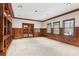 Elegant living room with wood paneled wainscoting, built-in shelving, and natural light at 4865 Meadow Park Ln, Suwanee, GA 30024