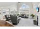 Spacious living room with soaring ceilings, large arched window, fireplace and modern decor at 4865 Meadow Park Ln, Suwanee, GA 30024
