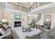 A beautiful living room with a fireplace, hardwood floors, and a stunning staircase at 4865 Meadow Park Ln, Suwanee, GA 30024