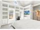 Bright main bedroom featuring custom built-ins, a window desk, and a relaxing view at 4865 Meadow Park Ln, Suwanee, GA 30024