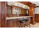 Custom wet bar with granite countertops, wood cabinets, and barstool seating at 4865 Meadow Park Ln, Suwanee, GA 30024