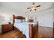 Comfortable bedroom featuring hardwood floors, a ceiling fan, and a tray ceiling at 31 Roberson Ne Dr, Cartersville, GA 30121