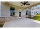 Back patio with ceiling fan, brick facade, and door leading into the home at 3114 Thicket Ln, Atlanta, GA 30349