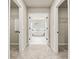 Hallway view to luxurious bathroom features soaking tub and dual walk-in closets for ample storage at 3114 Thicket Ln, Atlanta, GA 30349