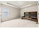 Bedroom features neutral walls and carpets, tray ceiling and dark-stained bed frame at 3114 Thicket Ln, Atlanta, GA 30349