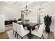 Elegant dining room with coffered ceilings, wainscoting, and a modern chandelier at 3114 Thicket Ln, Atlanta, GA 30349