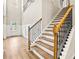 Grand foyer features hardwood floors, elegant staircase with iron spindles, and wainscoting at 3114 Thicket Ln, Atlanta, GA 30349