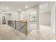 Spacious hallway with neutral carpet, wood and iron banister and several rooms leading from it at 3114 Thicket Ln, Atlanta, GA 30349