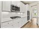 Gourmet kitchen features stainless steel appliances, white cabinets, and stylish backsplash at 3114 Thicket Ln, Atlanta, GA 30349