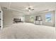 Large main bedroom features tray ceiling, plush carpeting, and multiple windows providing ample natural light at 3114 Thicket Ln, Atlanta, GA 30349