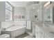 Spacious bathroom featuring dual sinks, tile shower with glass door, soaking tub, and modern fixtures at 424 Lindbergh Ne Dr # 201, Atlanta, GA 30305