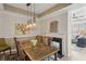 Dining room with a wooden table, modern lighting, fireplace, and views to the living area at 424 Lindbergh Ne Dr # 201, Atlanta, GA 30305