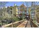 Multi-story condo building with a bridge walkway and mature trees at 424 Lindbergh Ne Dr # 201, Atlanta, GA 30305