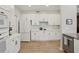 Well-lit kitchen featuring modern appliances, white cabinets, and hardwood flooring at 424 Lindbergh Ne Dr # 201, Atlanta, GA 30305