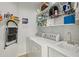 Bright laundry room featuring modern washer, dryer, sink, and ample shelving for storage and organization at 424 Lindbergh Ne Dr # 201, Atlanta, GA 30305