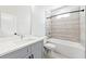 Well-lit bathroom showcasing a modern vanity with a sleek countertop, complemented by a tub-shower combo with stylish tiling at 622 Bellemeade Nw Ave # 3, Atlanta, GA 30318