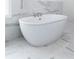 Close up of freestanding bathtub with marble tile and modern fixtures at 622 Bellemeade Nw Ave # 3, Atlanta, GA 30318